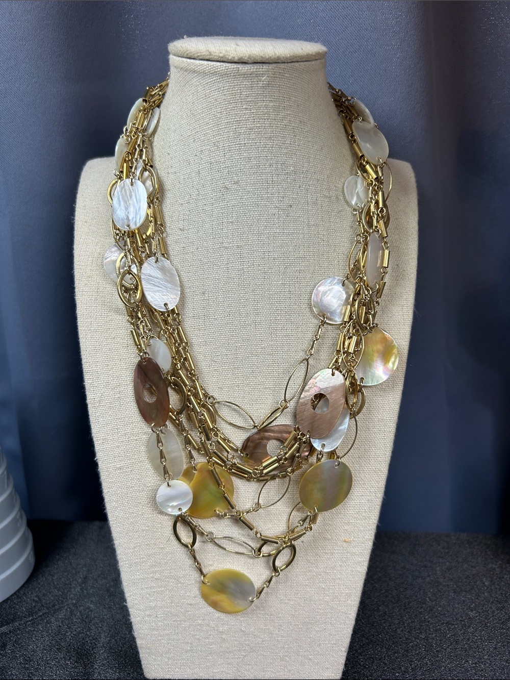 Multi-strand gold-tone necklace with Mother of Pearl Discs